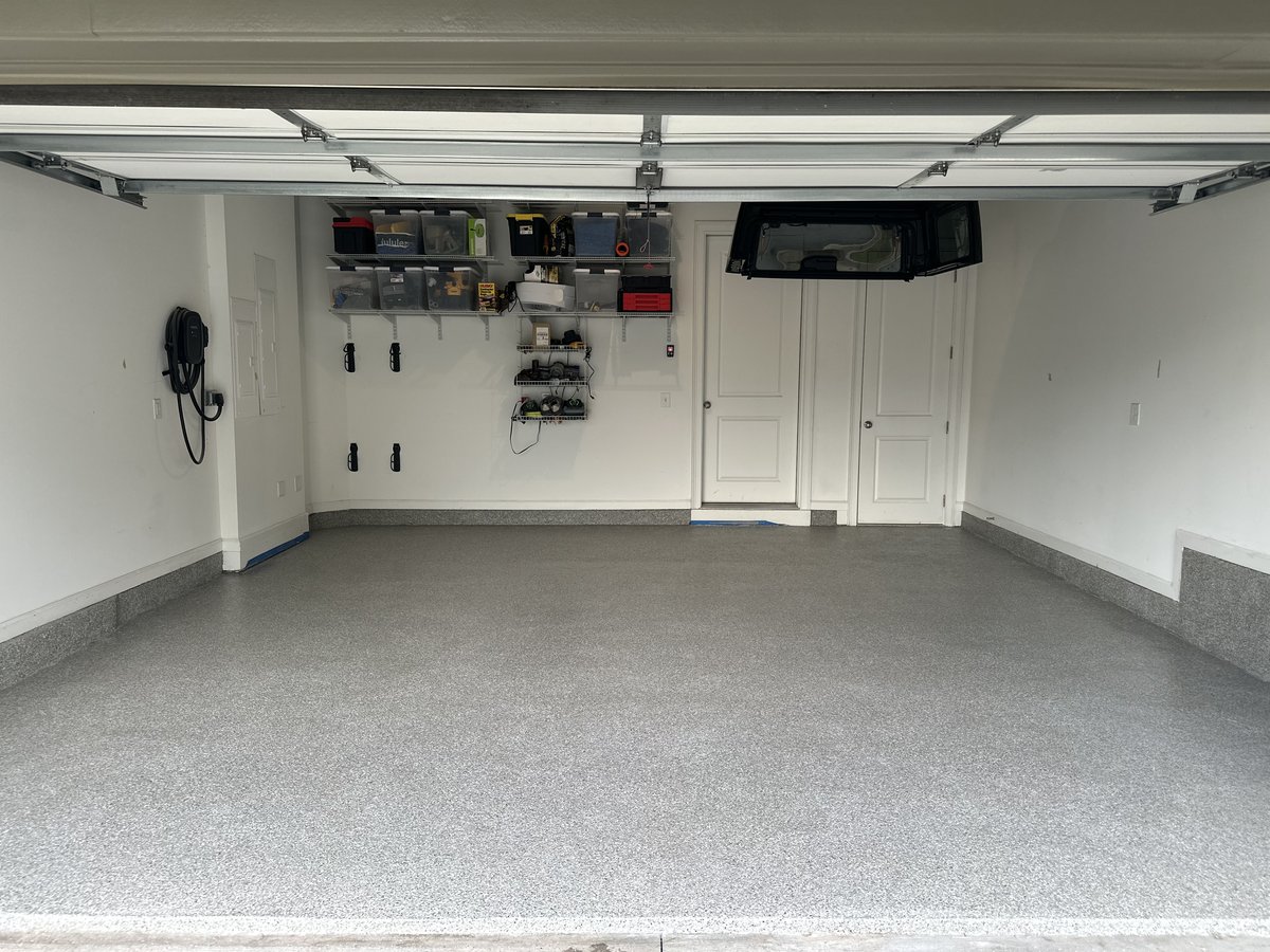 Garage floor after coating - clean speckled polyurea finish