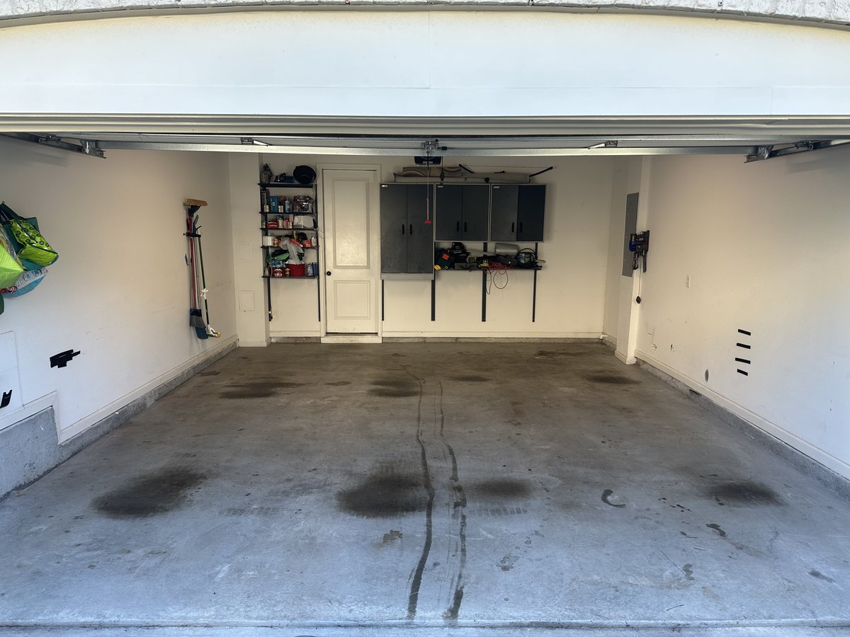 Garage floor before coating - worn concrete with tire marks